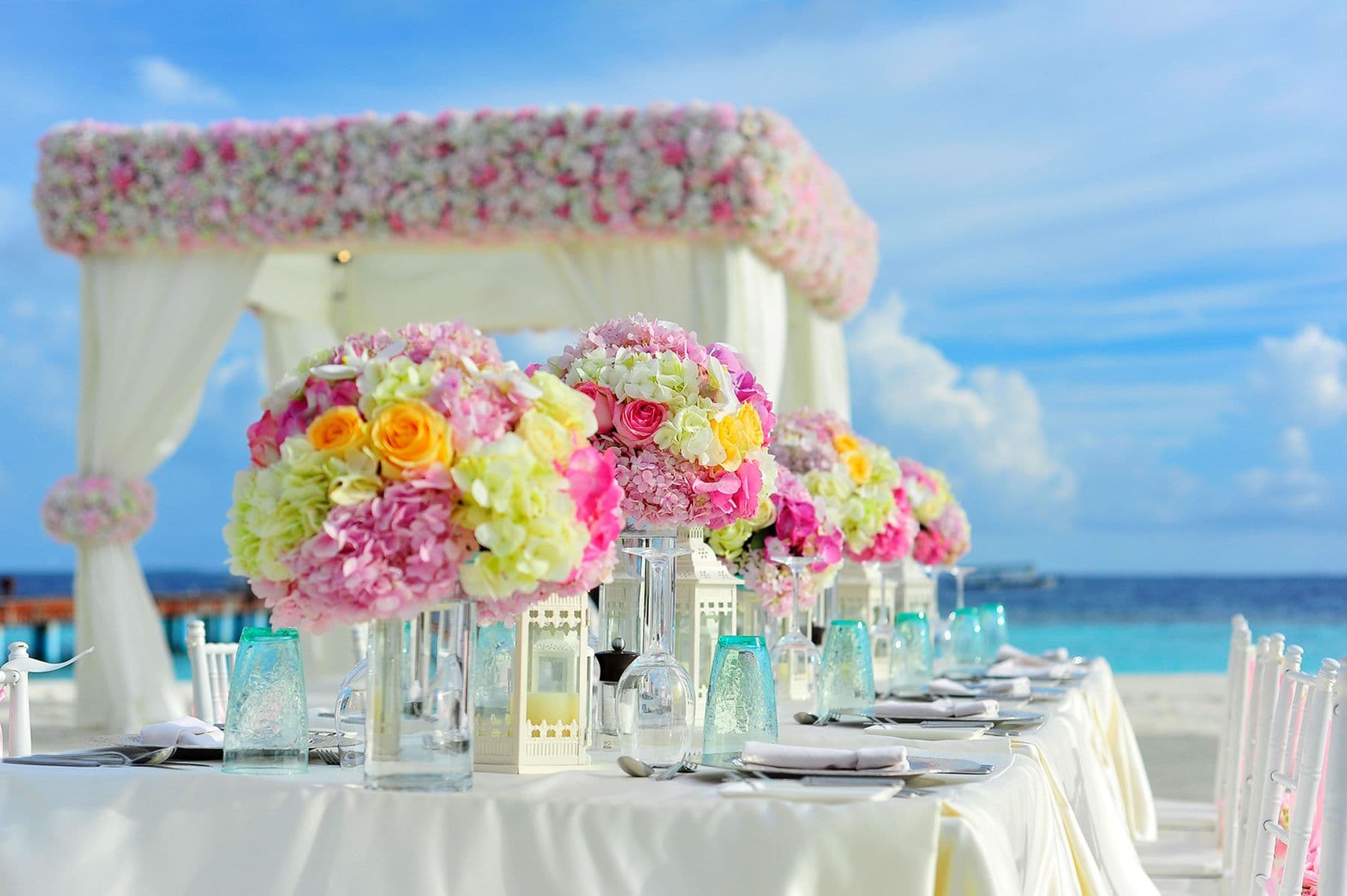 Warmly lit tables and decor prepared for an elevated evening event